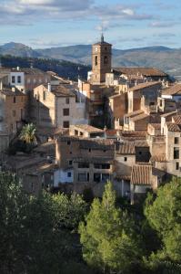 a village with a clock tower on a hill at Hostal Rural Letur in Letur