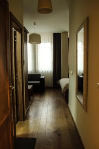 a hallway with a room with a bed and a mirror at B&B Villa Panuka in Pančevo