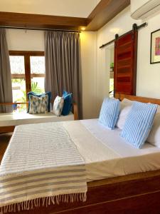 Ένα ή περισσότερα κρεβάτια σε δωμάτιο στο The Village Siargao