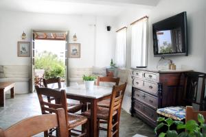 a dining room with a table and chairs and a mirror at Vidalis Hotel in Kionia