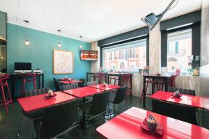 a restaurant with red tables and chairs in a room at Executive Business Hotel in Bari