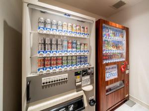 a refrigerator filled with lots of bottles of soda at Super Hotel Takamatsu Kin en kan in Takamatsu