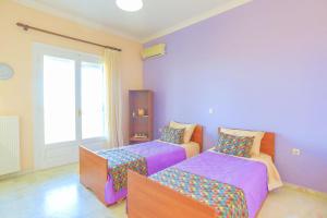 Postel nebo postele na pokoji v ubytování Villa Eftihia