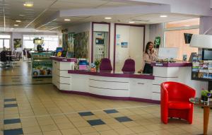 a woman standing at a counter in a store at Association Villa Saint Camille in Théoule-sur-Mer