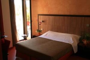 Säng eller sängar i ett rum på L'Ecce Sphero