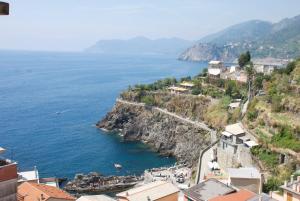a view of the ocean from a town on a cliff at Appartamenti Da Paulin in Manarola