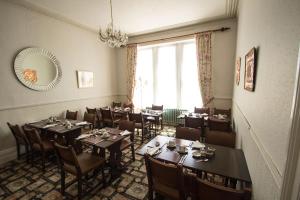 a dining room with tables and chairs and a mirror at Glenleigh Bed and Breakfast in Marazion