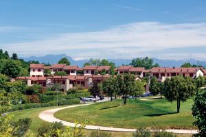 a resort building with a winding road in a park at Golf Residenza in Peschiera del Garda