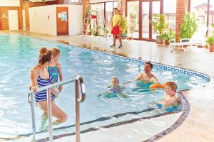 a group of people playing in a swimming pool at St. Margaret's Hotel in Saint Margaretʼs at Cliffe