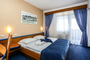 a hotel room with a bed and a window at Hotel Dražica - Hotel Resort Dražica in Krk