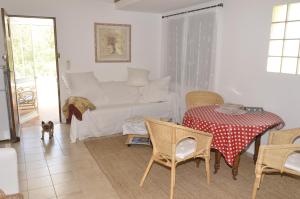 a living room with a table and a couch at La petite Cigale in Cesseras