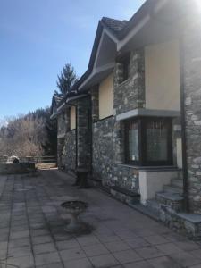 a stone house with a patio and a building at Chez Bruna in Doues