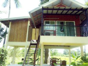 a house with a staircase leading up to it at Hallo Villa Khanom in Khanom