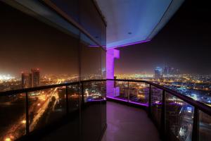 a view from a balcony of a city at night at Majestic City Retreat Hotel ( Formerly Majestic Hotel Tower) in Dubai
