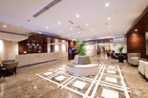 a lobby of a hotel with a waiting area at Majestic City Retreat Hotel in Dubai
