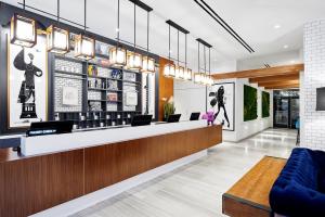 a lobby of a restaurant with a counter and chairs at INNSiDE by Meliá New York Nomad in New York