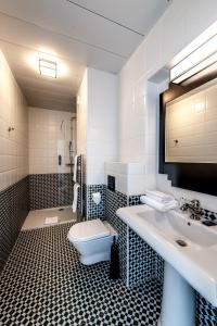 a bathroom with a sink and a toilet at Best Western Hôtel Journel Antibes Juan-les-Pins in Antibes
