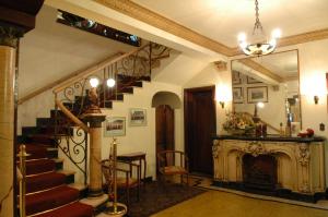 a living room with a staircase and a fireplace at Tamareiras Park Hotel in Uberaba