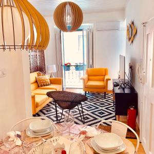 a living room with a table and chairs at Apartments Alfacinha Ajuda in Lisbon