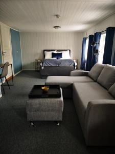 a living room with a couch and a bed at Henningsvær Guesthouse in Henningsvær