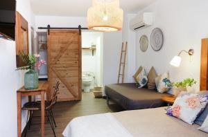 A bed or beds in a room at Hostal Sa Malica