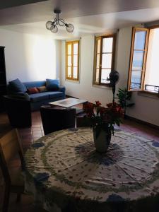 a living room with a table and a couch at Appartement coeur du vieux Nice in Nice