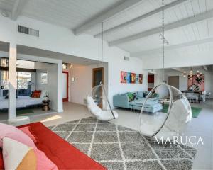 a living room with two chairs and a couch at Villa Finola in Palm Springs +31 photos