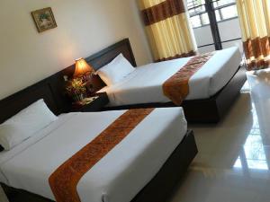 A bed or beds in a room at Kong Garden View Resort Chiang Rai