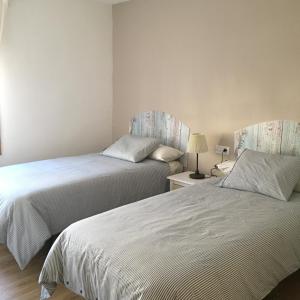 two beds sitting next to each other in a room at La Manguita Bardenas in Arguedas +28 photos