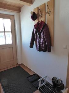 a room with a jacket hanging on a wall at Ferienwohnung Bolsterlang in Bolsterlang