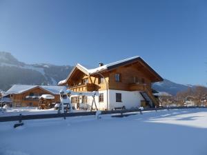 a ski lodge in the snow with a building at Ferienwohnung Bolsterlang in Bolsterlang