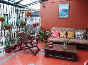 a patio with a couch and a chair and a table at Qoricancha B&B Cusco in Cusco