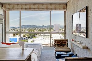 a bedroom with a bed and a large window at The LINE Hotel LA in Los Angeles
