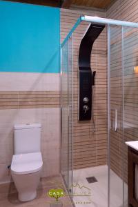 a bathroom with a shower with a toilet and a phone at Casa Chaluca in La Aldehuela +59 photos