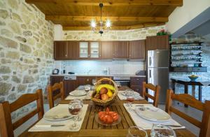 a kitchen with a wooden table with a basket of fruit at Villa Kaladare - Private Pool & Quiet Relaxing Stay in Kalandares
