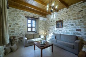 a living room with a couch and a table at Villa Kaladare - Private Pool & Quiet Relaxing Stay in Kalandares