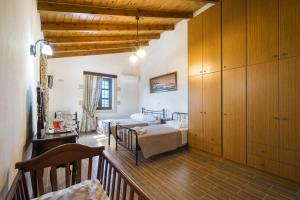 a bedroom with a bed in a room with wooden cabinets at Villa Kaladare - Private Pool & Quiet Relaxing Stay in Kalandares