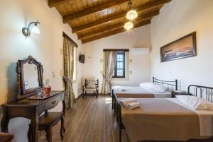 a hotel room with two beds and a mirror at Villa Kaladare - Private Pool & Quiet Relaxing Stay in Kalandares