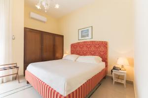 a bedroom with a large bed with a red headboard at Masseria Sant'Anna in Bari