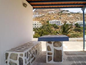a room with a stone bench and a view of a city at Andromeda in Ios Chora