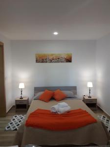 a bedroom with a large bed with two lamps at Tabua Village in Ribeira Brava