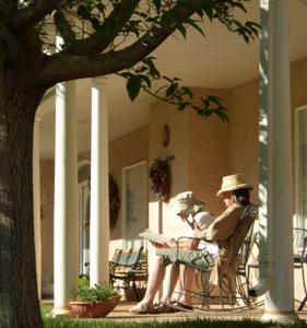 two women sitting in chairs on the porch of a house at Novel House Inn at Zion in Springdale