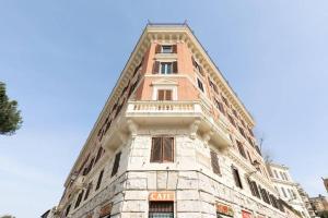 a tall building with a sign on the side of it at View Colosseo From Jacuzzi in Rome