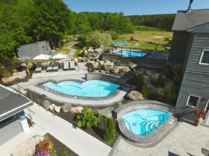 a large swimming pool in front of a house at Millcroft Inn & Spa in Alton