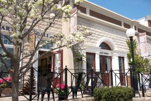 a building with a flowering tree in front of it at Inn On The Twenty in Jordan