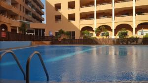an empty swimming pool in front of a building at Oceanside Apartment in El Medano in El Médano