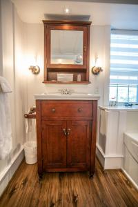 a bathroom with a sink and a mirror at Auberge Seigneurie des Monts in Sainte-Anne-des-Monts +50 photos