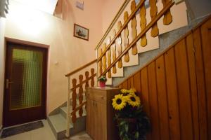 a hallway with a staircase with a sunflower on it at Apartments Mira in Starigrad