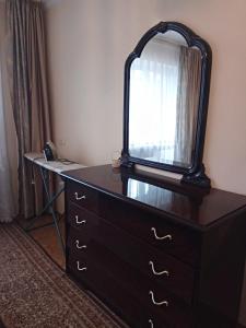 a dresser with a mirror on top of it at Apartment Chernihivska 13 in Shostka