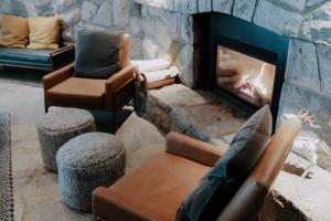 a living room with a fireplace and couches at Adara Hotel in Whistler +31 photos